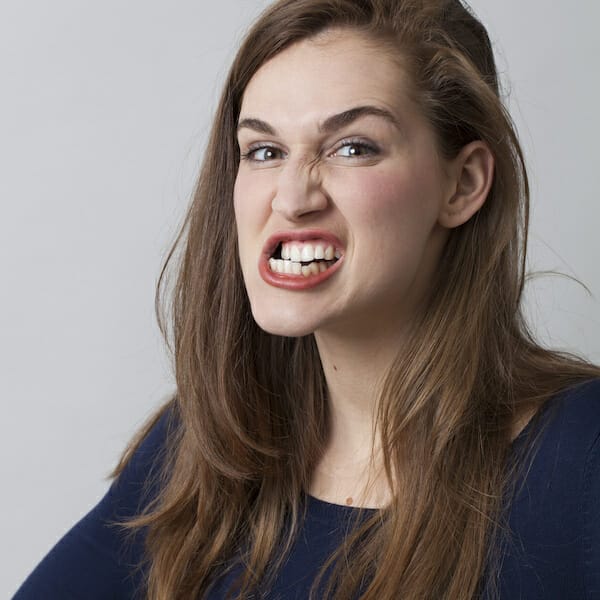 A young woman grinding her teeth, tooth misalignment injury